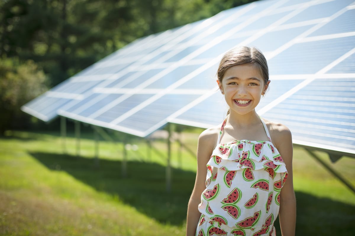 child standing by agricultural solar